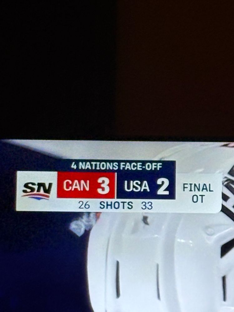 Photo of TV screen showing Team Canada victory score (3-2) in 4 Nations Face Off championship game. 