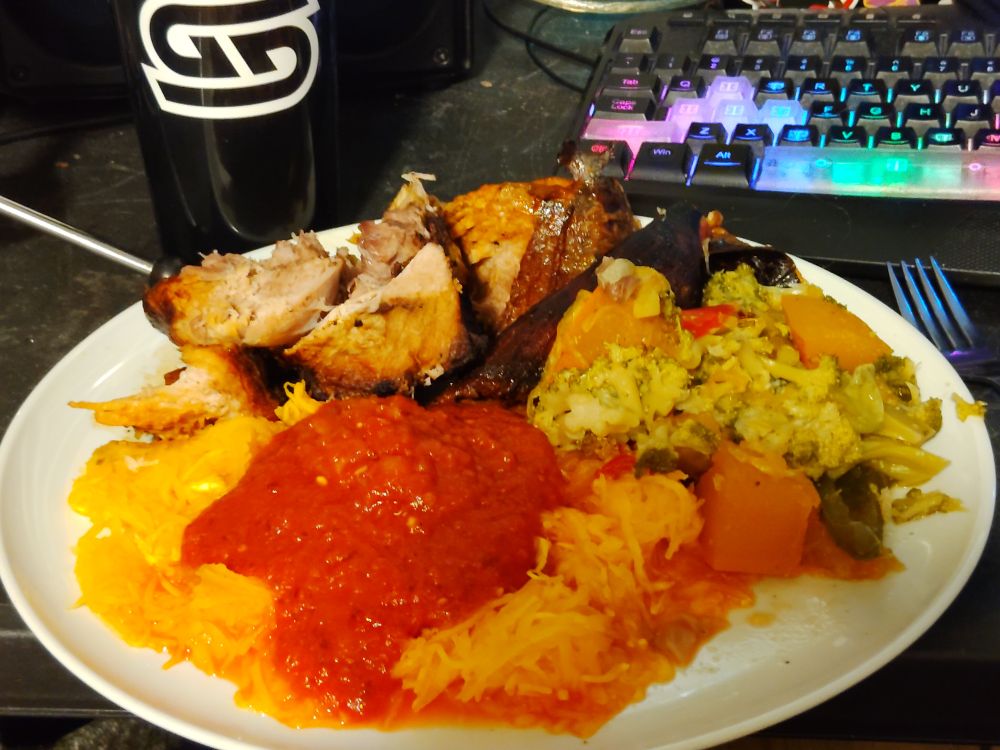 A plate of pork roast, pumpkin spaghetti and steamed vegetables.