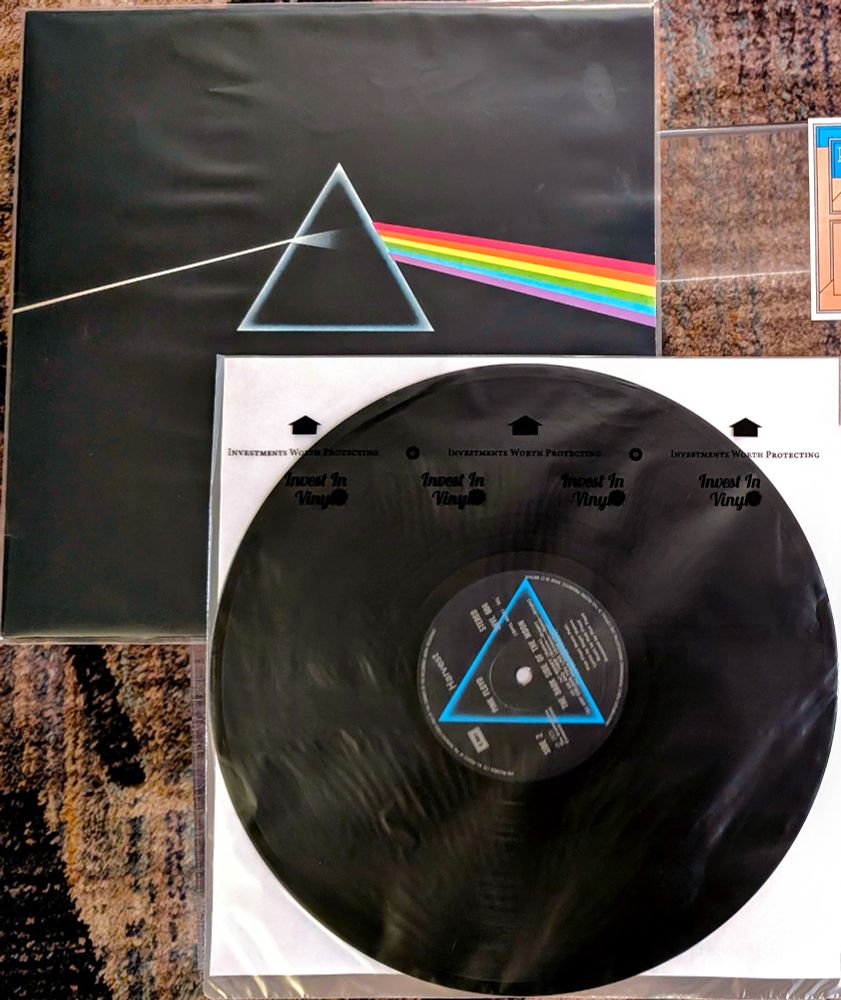 Pink Floyd's Dark Side of the Moon vinyl LP
Album cover, top left, is a solid black background with an illustration "inspired by a photograph of a prism with a beam of white light projected through it and emerging in the colours of the visible spectrum" found in a textbook

Vinyl disc, lower right, label has blue triangle on black background

Selection from Dad's Collection

#nowplaying #nowspinning #vinylsky #vinyl #vinylcommunity #musicsky