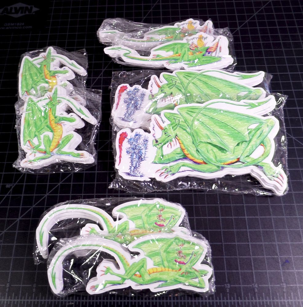 Stickers from _The Dragon of Wantley_ comic (https://www.drownedtownpress.com/dragwant.html) -- Dragon beating chest, Dragon with a flaming burp while leaning on a house, Dragon facing More of More-Hall (in armor), Dragon eating cow like a bunch of grapes.