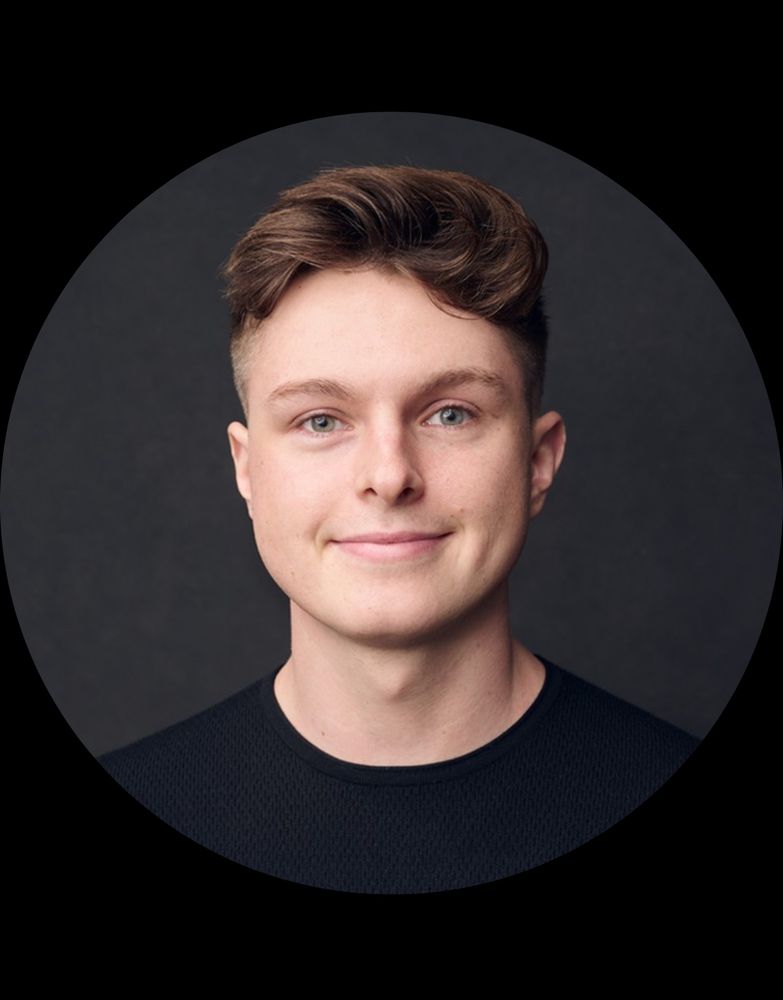 Photo of Nate Cavanaugh, the twenty-something DOGE affiliate who is the new acting president of USIP. He is a young white man with brown hair and blue eyes. He’s wearing a black shirt and smiling at the camera. 