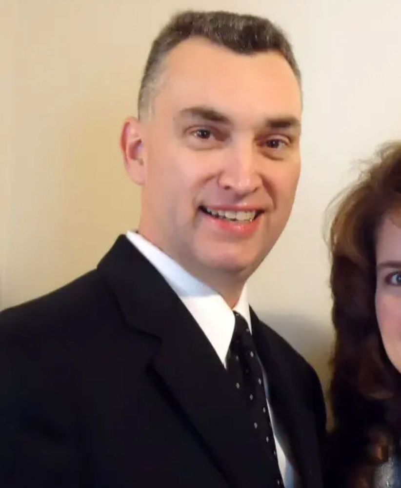 Vance Boelter, a white man in his 50s with gray hair in a suit. 