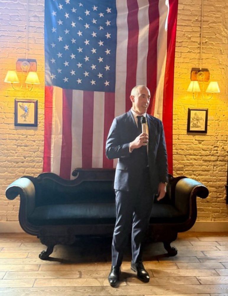Bove in a suit gives remarks in front of American flag at Butterworth’s 

Photo credit: Mike Davis/Article 3 project on Twitter