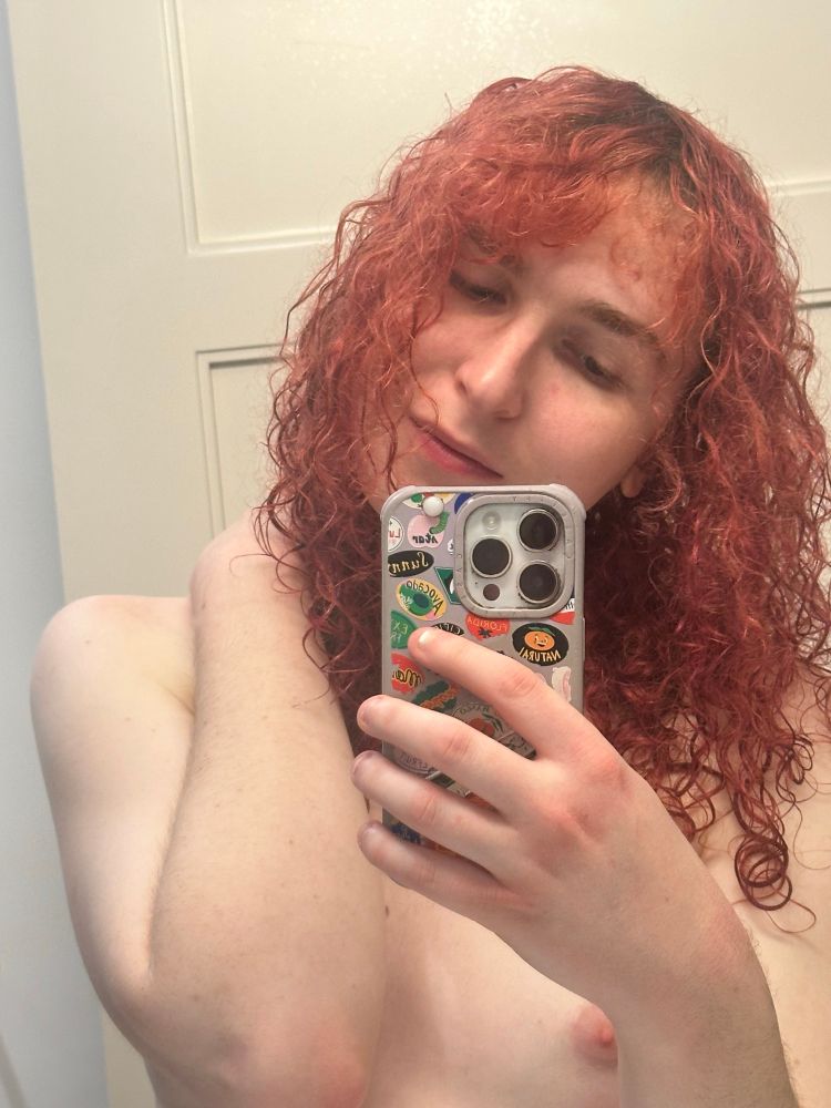 me taking a topless pic with my hair wet and let down. i got my hand on the back of my neck and and im tilting my head to the side and wait what's that towards the bottom right