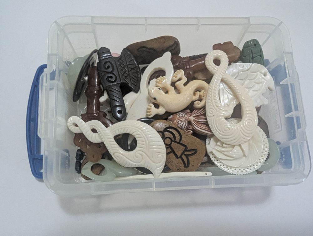A box of miscellaneous carved beads, many from the previous photo but also others.
