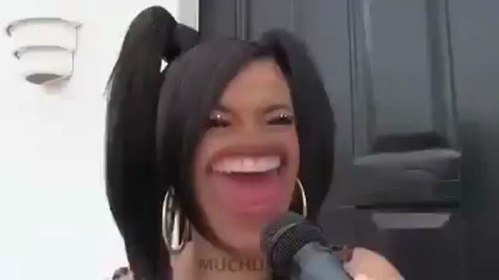 a woman with pigtails is making a funny face while holding a microphone .