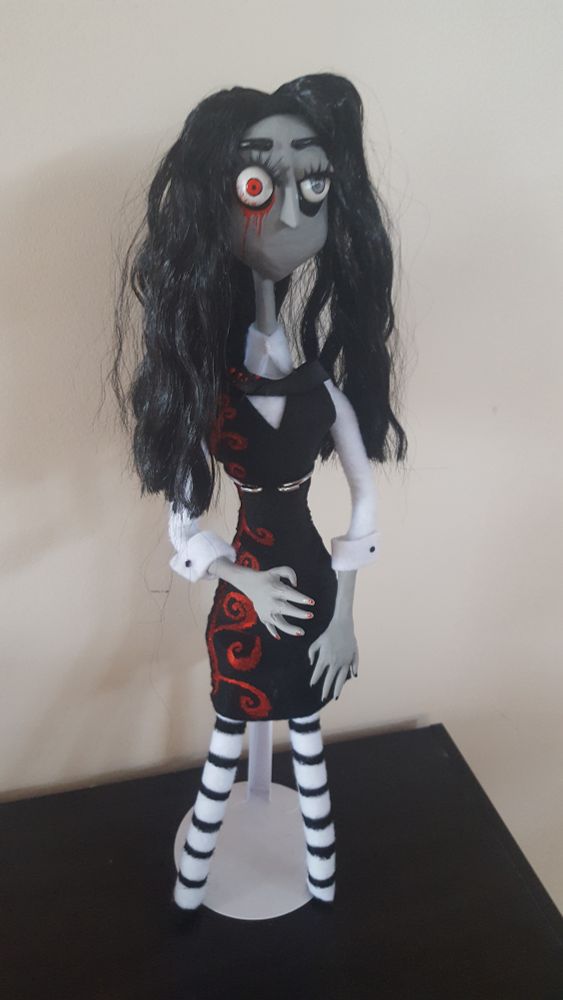 Doll standing on table.