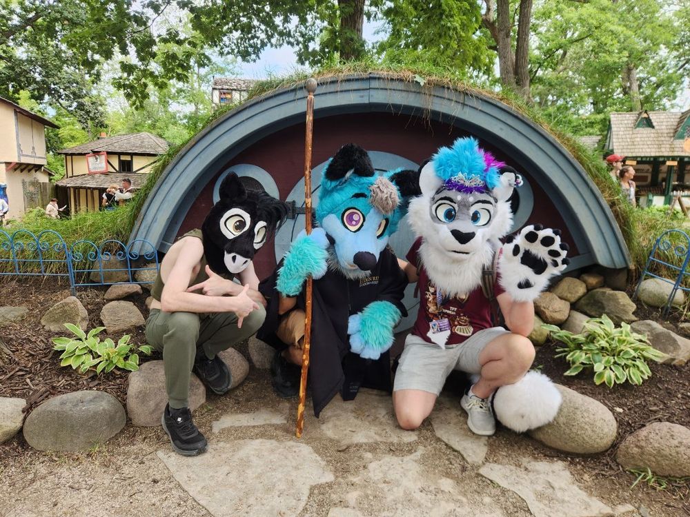 Liracle, Lix, and Silver in front of a hobbit house