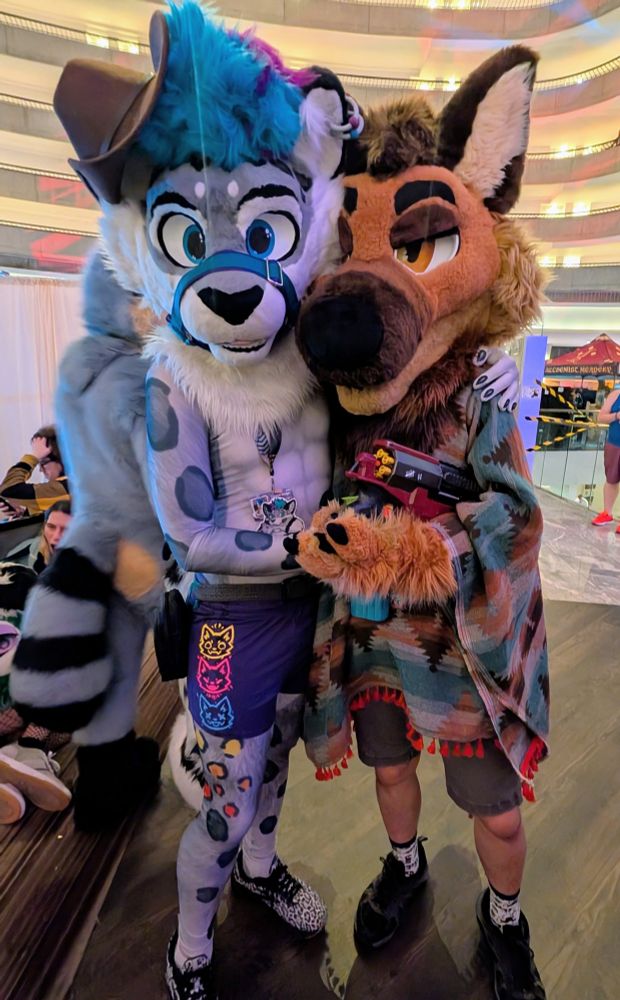 Silver and Trip standing together in the lobby at FWA, with Silver wearing a cowboy hat and Trip in a poncho and holding a toy gun 