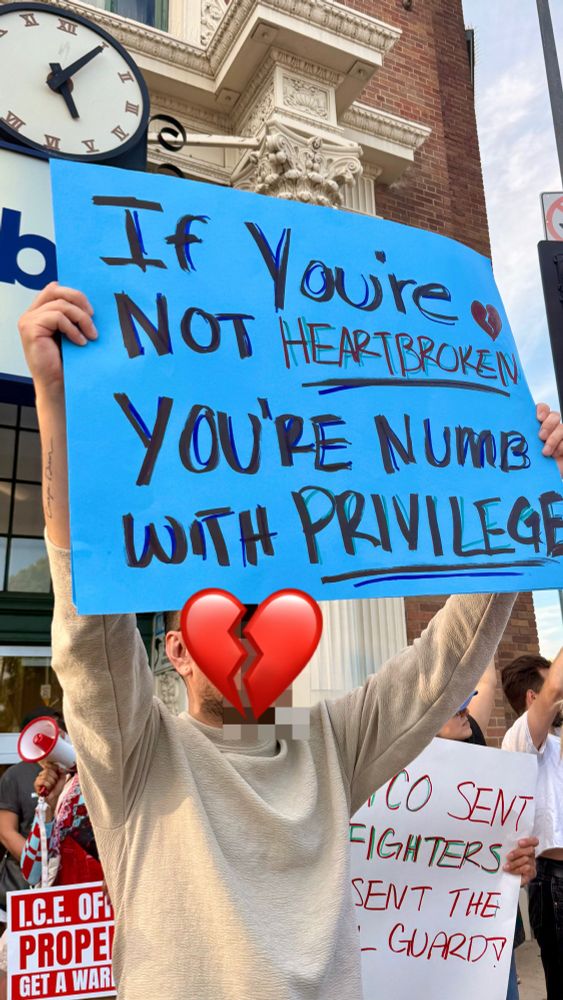 Protest sign: if you’re not heartbroken you’r numb with privilege 