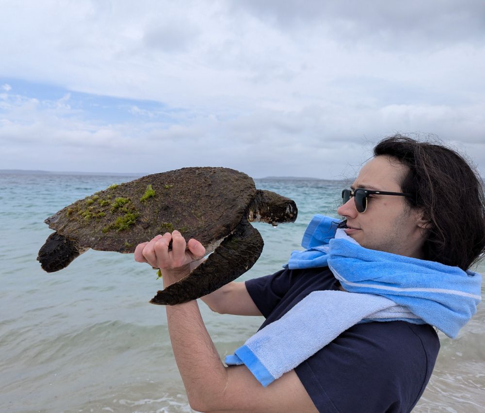 Charlie picks up a turtle. it was dead :(