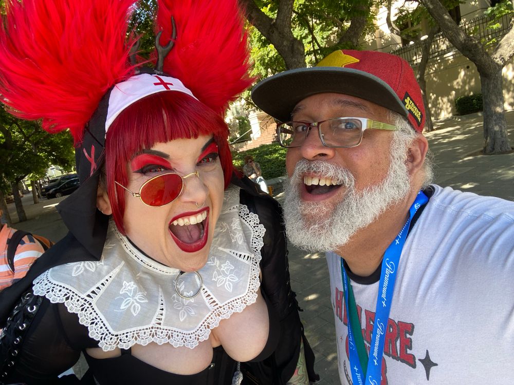 Alistair cosplayer and brown skinned man smiling