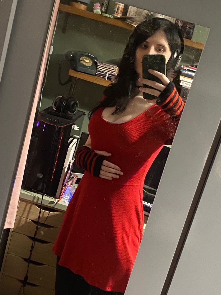 emi in a red dress and black and red striped arm warmers. they have black hair now look at it, compliment me on it >:3