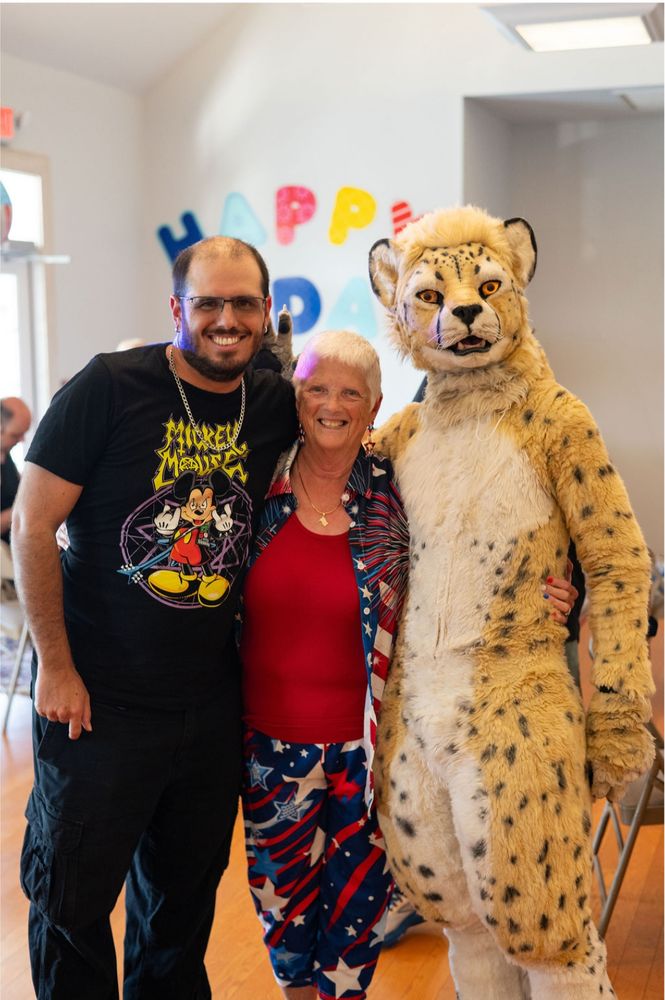 Standing with my brother and grandmother for a photo while wearing my fursuit.
