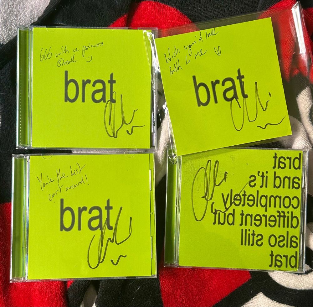 Signed Brat CDs with various messages by Charli written on them as well <3