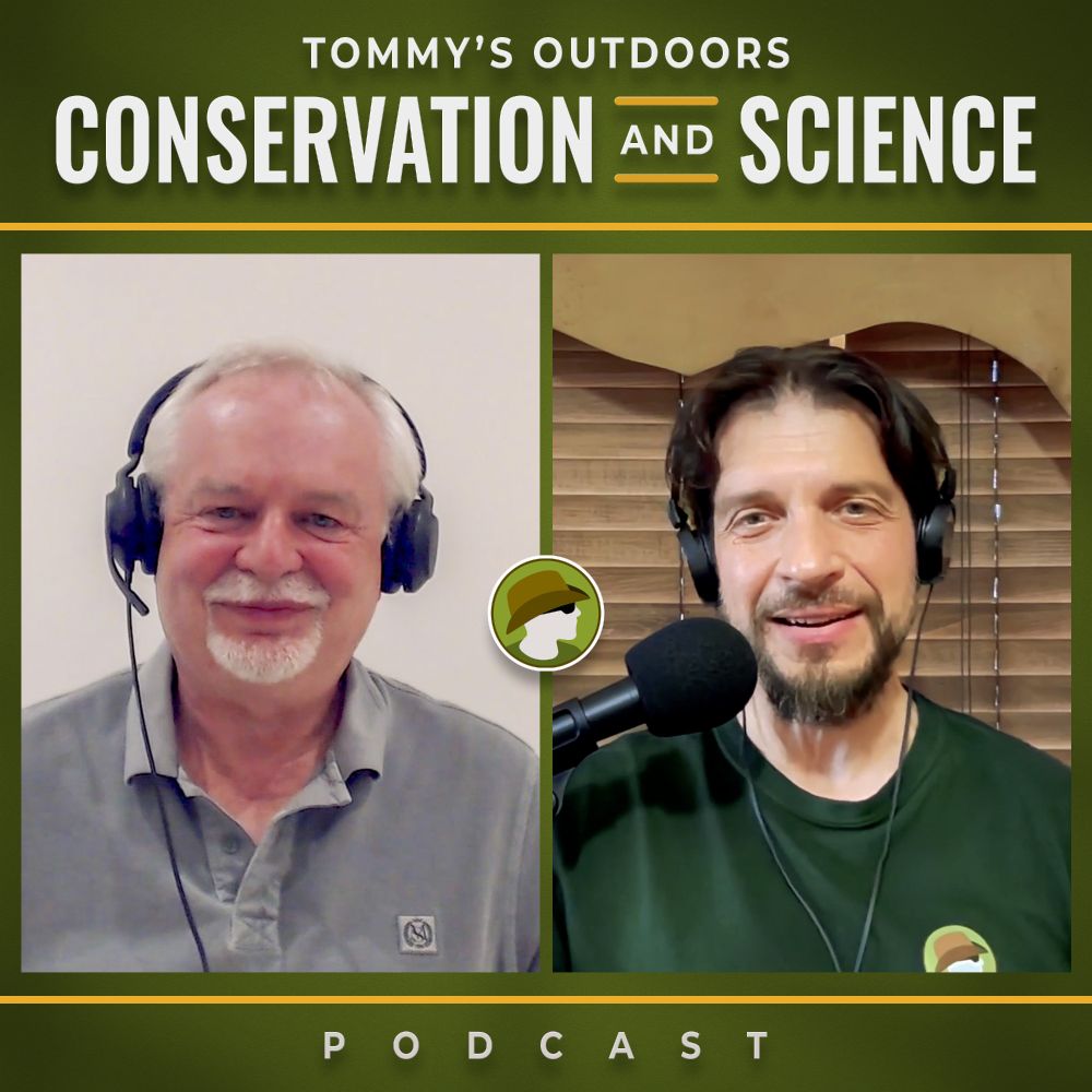 Podcast episode cover art featuring two men in a split-screen video call format. On the left is an older gentleman with white hair and a white beard, wearing a light grey collared shirt and black headphones, smiling warmly against a plain background. On the right is a younger man with dark hair and a goatee, wearing a green jumper and black headphones, positioned in front of a professional podcast microphone with wooden blinds visible in the background. The cover has a green and yellow colour scheme with "TOMMY'S OUTDOORS" at the top, "CONSERVATION AND SCIENCE" as the main title with decorative yellow lines, and "PODCAST" at the bottom.