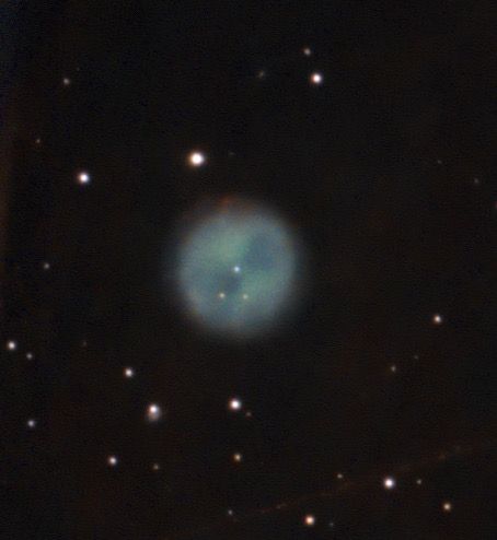 Owl Nebula (M97), nearly round greenish-blue cloud with blue central star and two darker patches line an hourglass (the owl's eyes, I think).