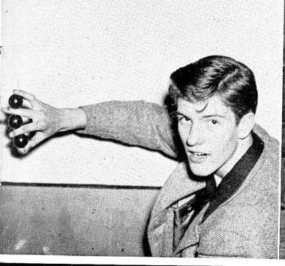 A very young Dick Van Dyke holding three balls between his fingers.