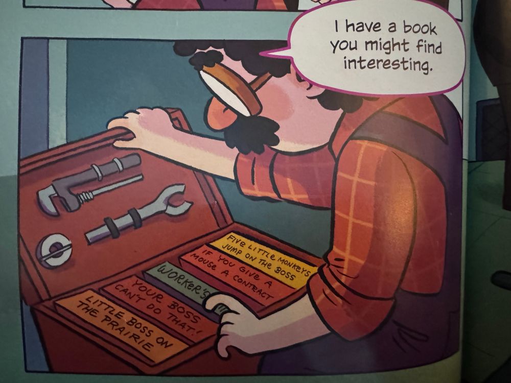 An undercover librarian opens a toolbox to reveal a bunch of books about union organizing.