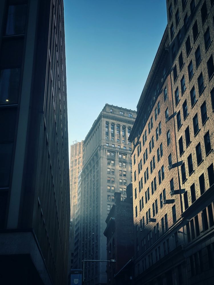 Sunlight shining through tall buildings 