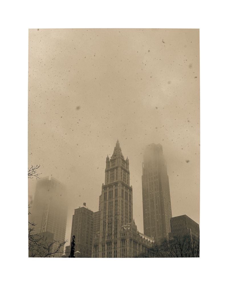 Snow in Manhattan. Tall buildings in the mist. Yellowish  filter