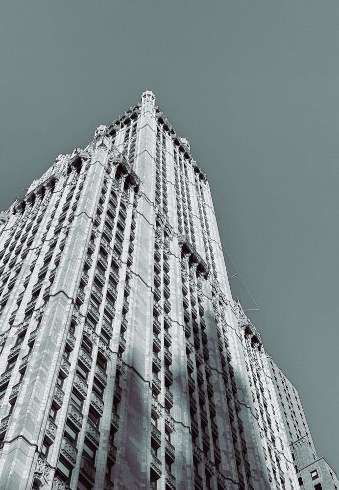 Tall stone skyscraper with shadows on it 