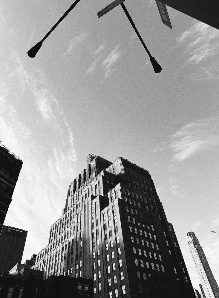 A tall building against a sky with a few cirris clouds 