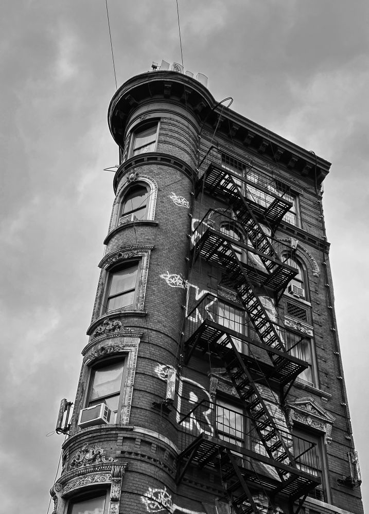 A tall free standing walk up apartment building 