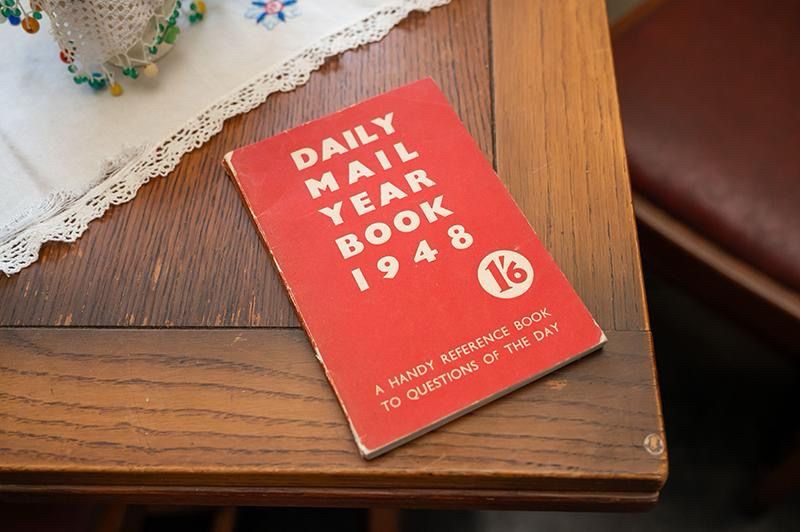 A small red book on a wooden table.