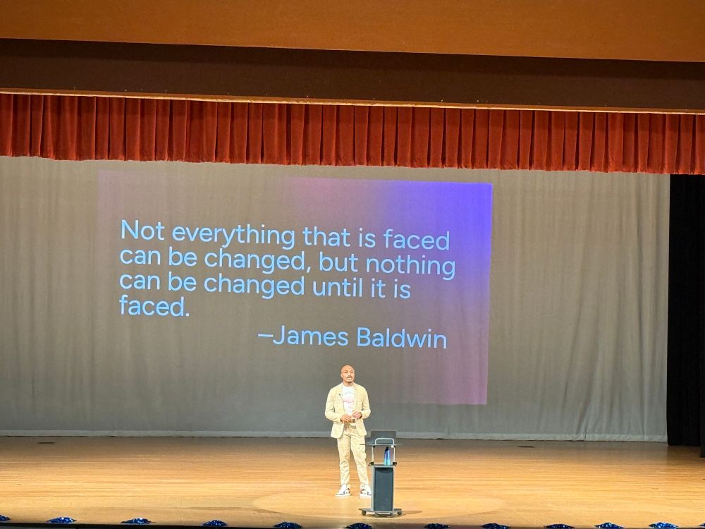 Dr. Gurley, our superintendent, on the stage with a James Baldwin quote behind him. “….but nothing can be changed until it is faced.”