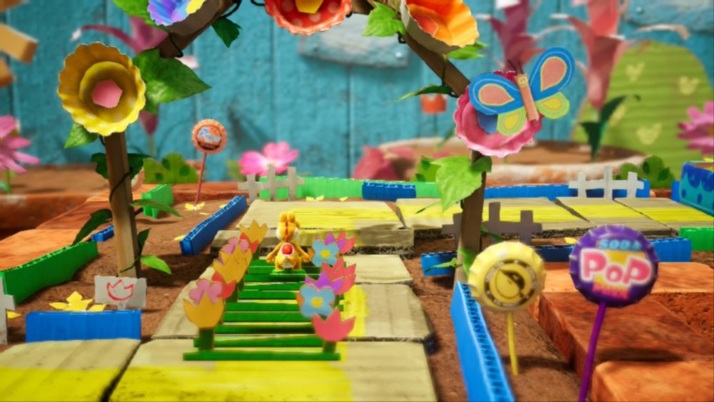 A yellow yoshi is walking away. This area is cute. It has lots of flowers.