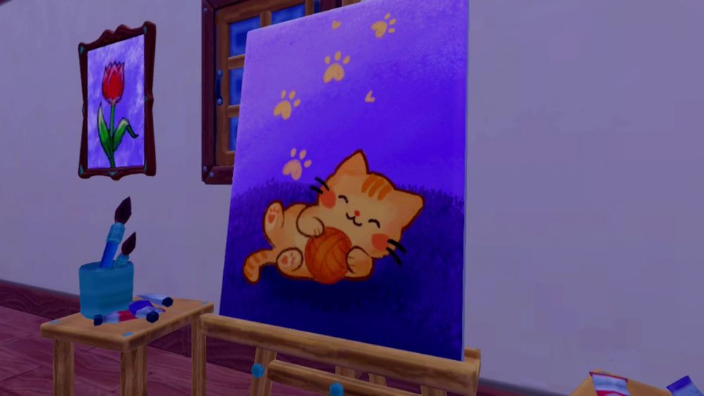 A painting of a kitty playing with a ball of yarn! Soooooo cute. You can see a picture of a tulip on the wall behind it. 