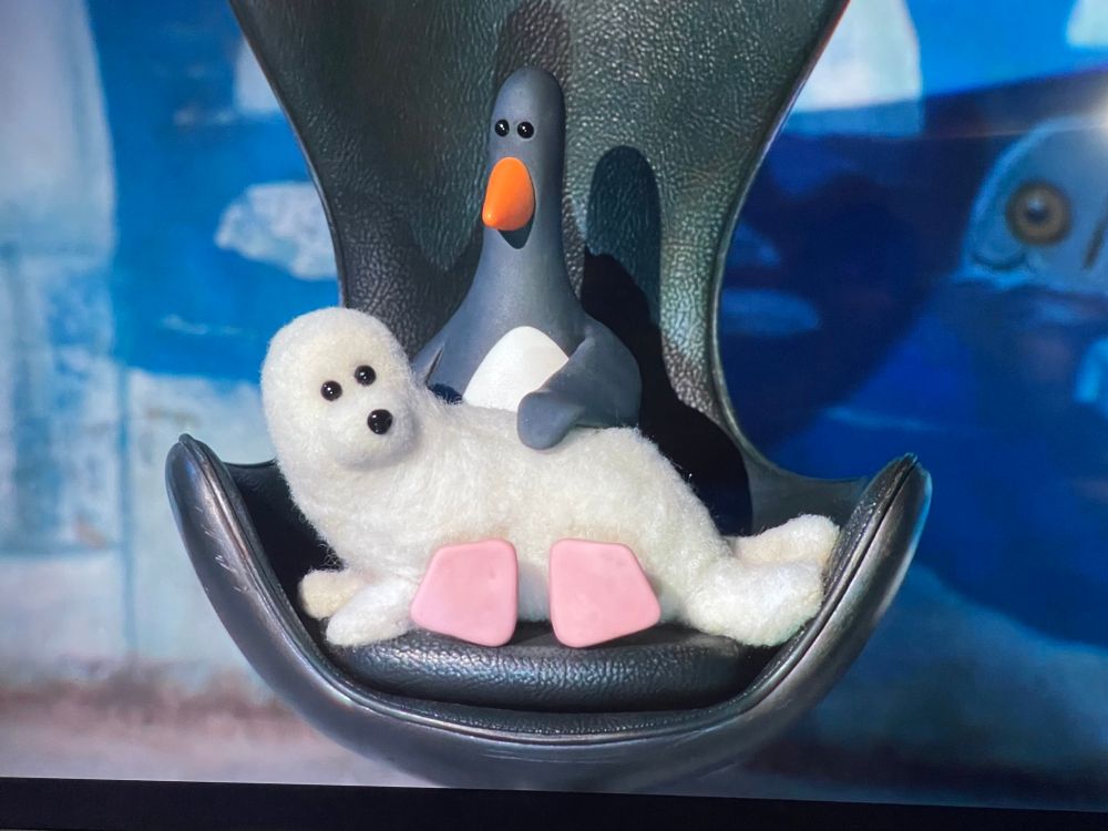 Feathers McGraw petting a seal