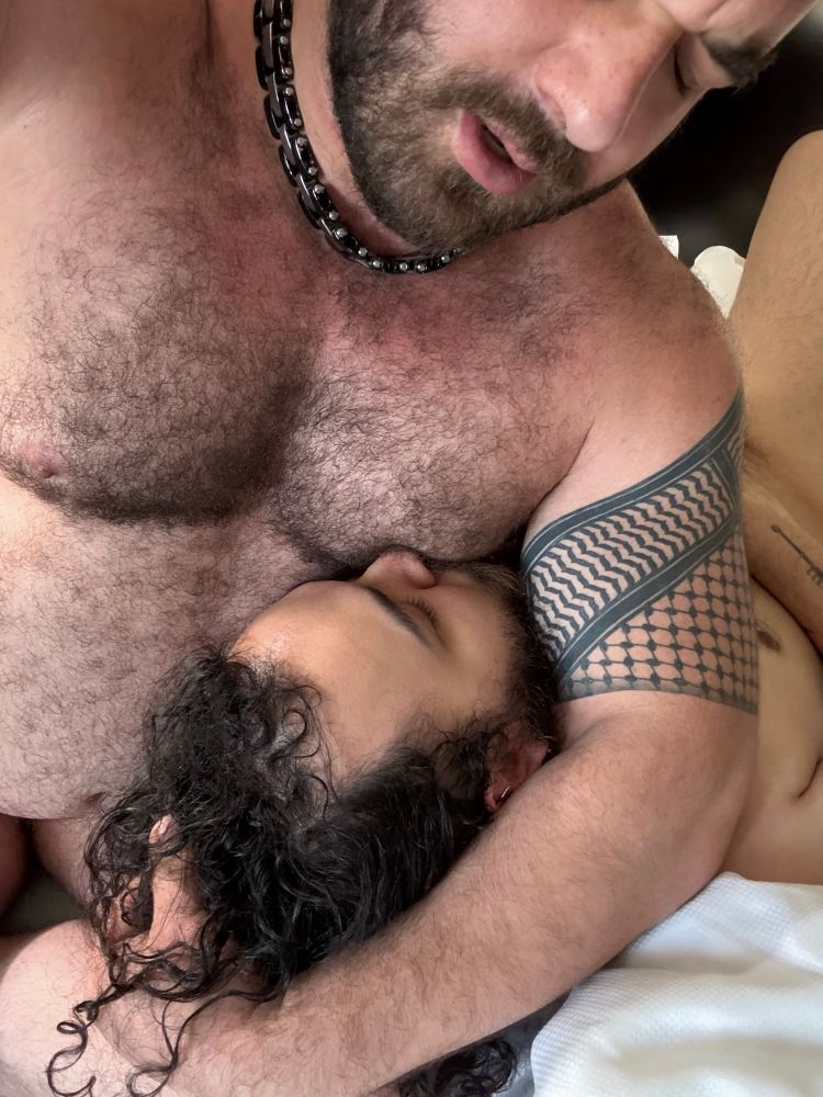 Me, sat on a bed, with my sub resting his head on my lap, my bicep wrapped around him supporting his head and him sucking on my nipple. 