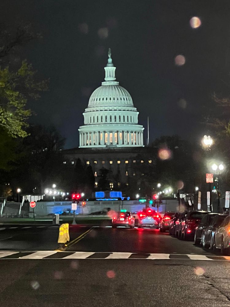 A rainy evening shot of the Capital Dome from April 2025. There appears to be a car double-parked. Full of crimes. 