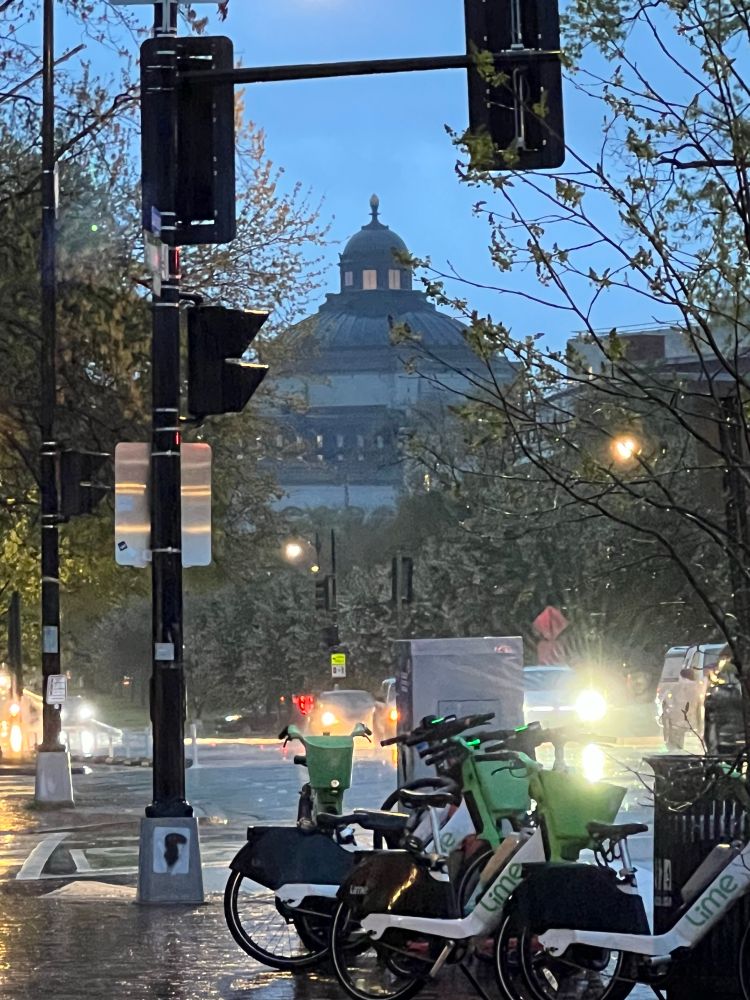 Another rainy evening shot, this time of the Library of Congress. The street is littered with Lime Bikes, properly lined up in a bike rack. One of the cars may not have their wipers on. Just overrun with crime. 
