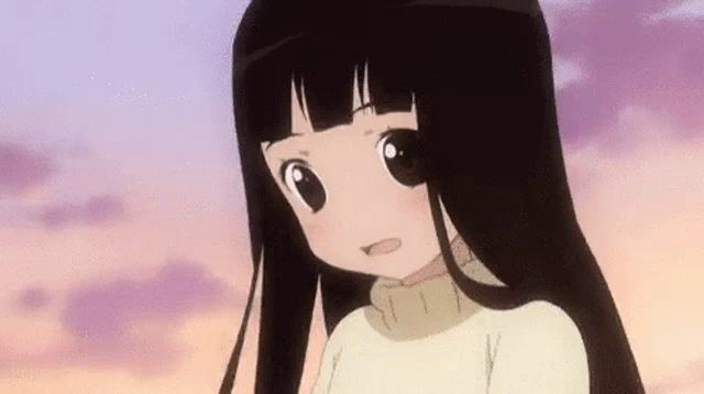 a girl with long black hair is wearing a white sweater and looking at the camera .