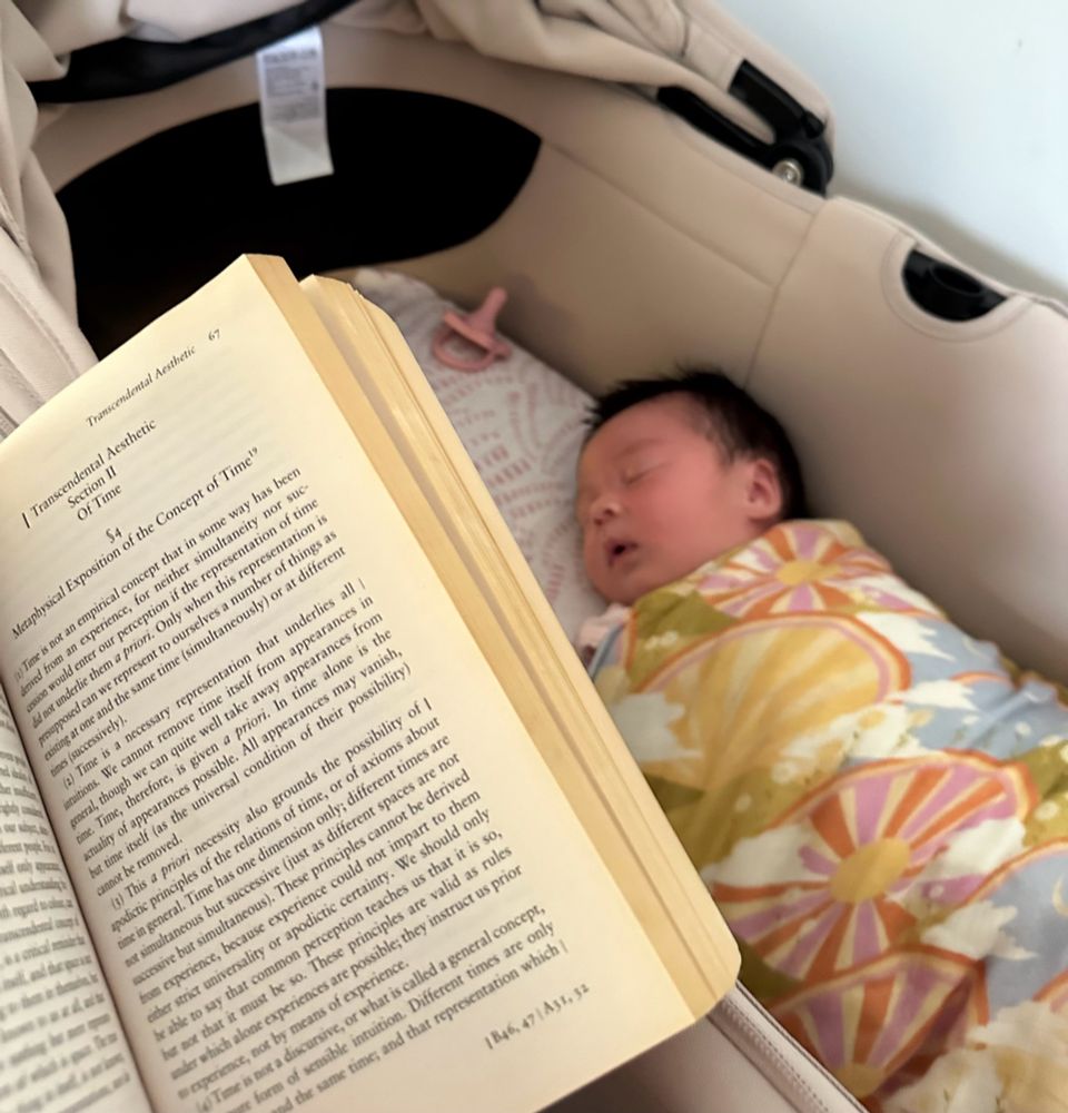 A POV of a sleeping baby, and a copy of Kanye critique of pure reason in the foreground. 