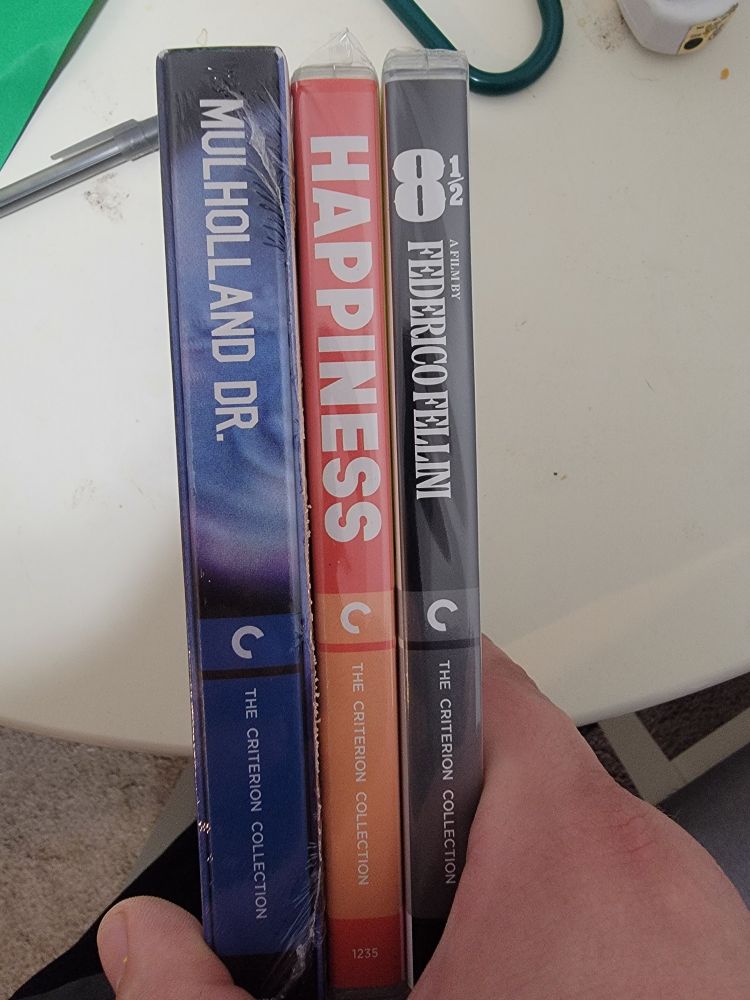 Spine view of the following 3 criterion cases:

Mulholland Drive
Happiness
8 1/2