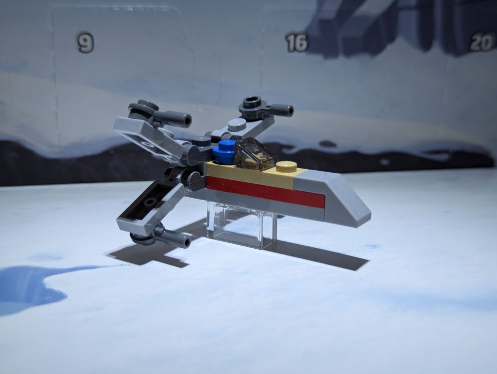 A micro-scale Lego model of a Star Wars X-wing fighter spacecraft