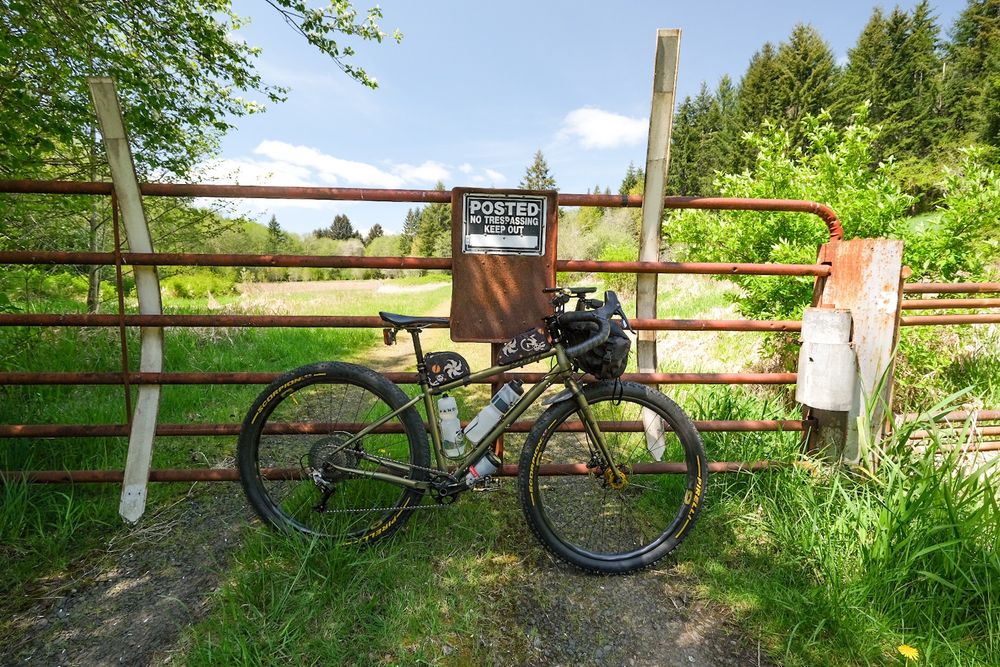 End of the line unfortunately. A bicycle leans against a locked gate with a no trespassing sign. I really wanted to keep going!