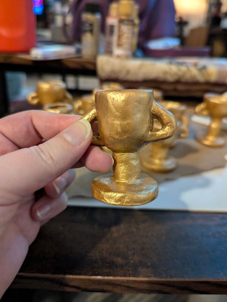 A closer shot of one trophy in my hand, painted gold but no slogan yet