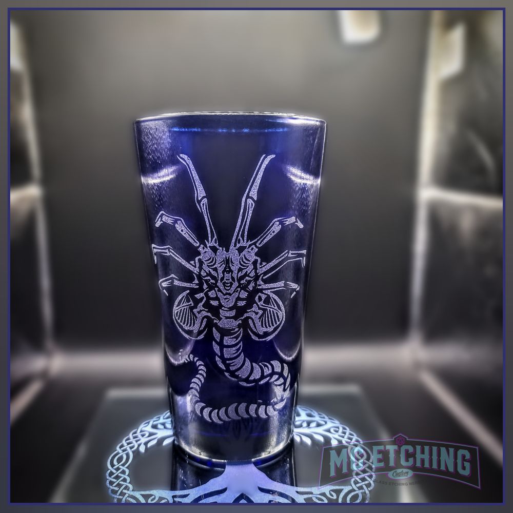 kobalt pint glass etched with a xenomorph facehugger