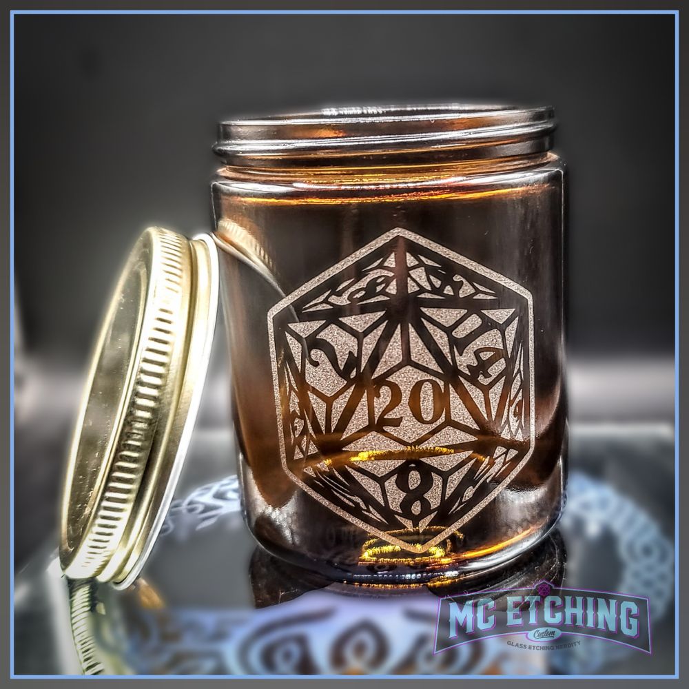 small brown glass jar with a lid etched with a stylized D20 dice design