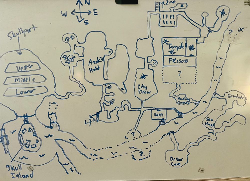 A whiteboard with a hand-drawn map of Skullport and the dungeons around it. 