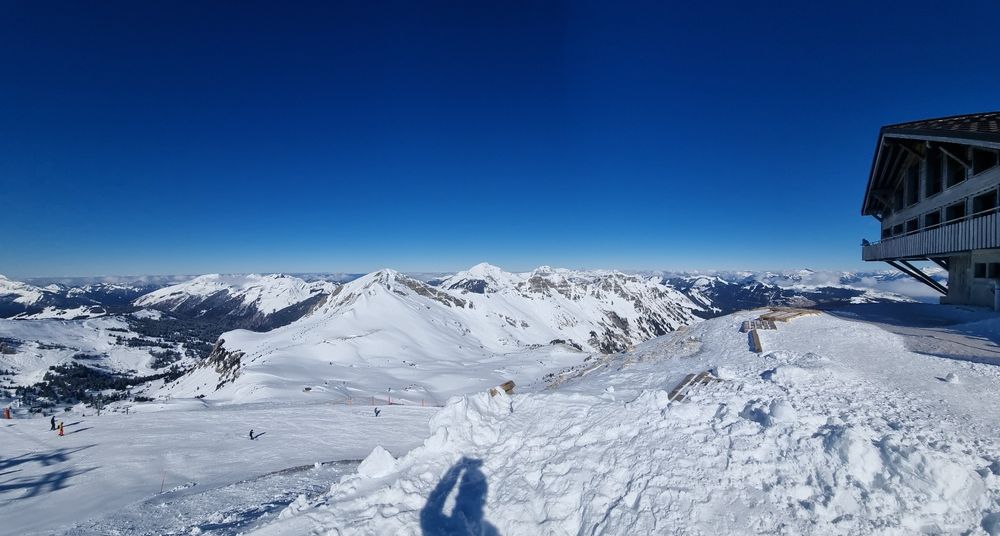 Blue skis and snowy mountains