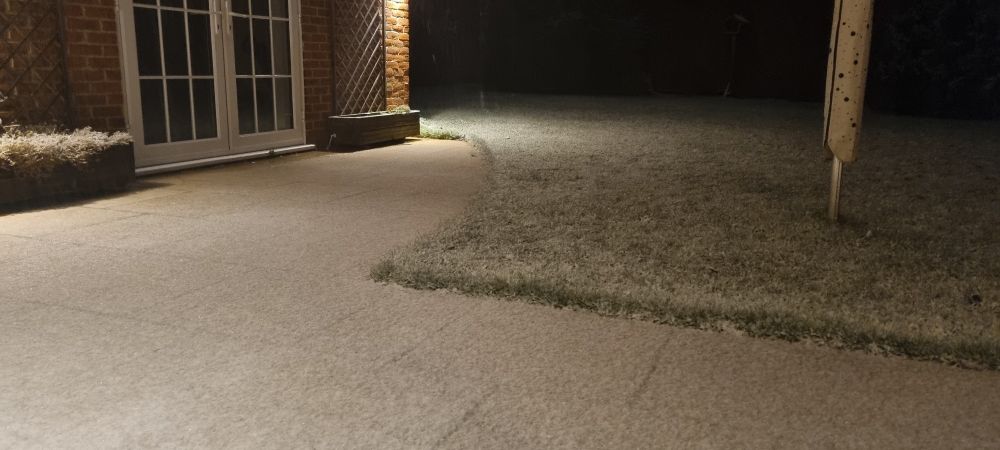 Thin layer of snow on the patio and garden.
