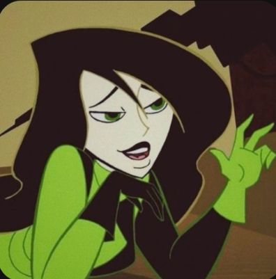 Very pale cartoon character with green eyes and black hair holding her hand up