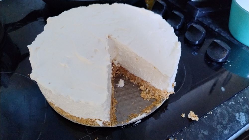 The cheesecake now out of the springform pan with a slice taken from it