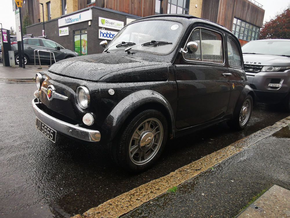 Front and side view of a black Abarth 500. 